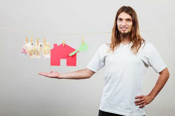 Man seller with money and house — Stock Photo, Image