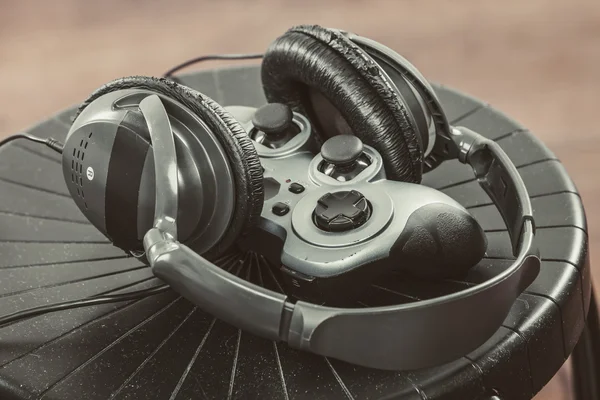 Joystick and headphones on chair — Stock Photo, Image