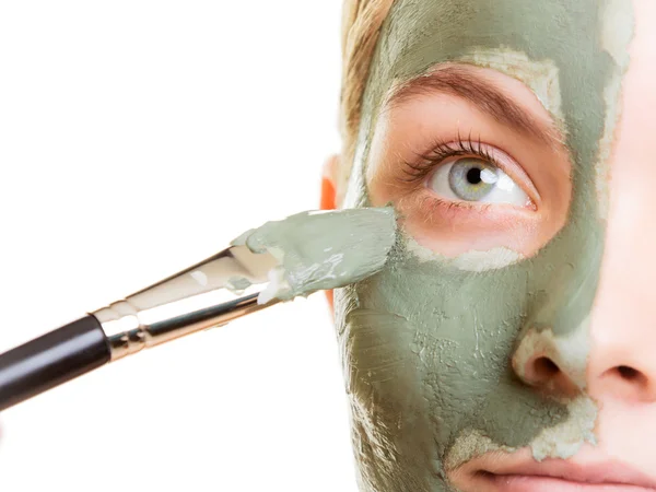 Woman applying with brush clay mud mask her face — Stock Photo, Image