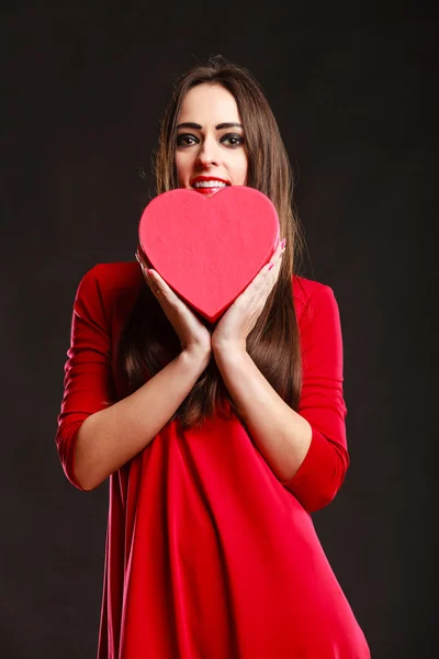 Girl in red holding heart box. — Stock Photo, Image