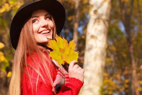 Woman holding big gold leaves — Stock Photo, Image