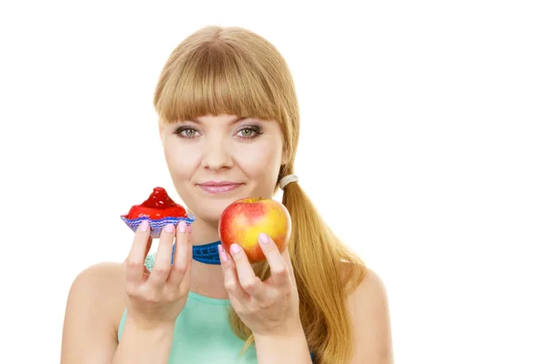 Woman choosing fruit or cake make dietary choice — Stock Photo, Image