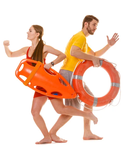 Lifeguards running with rescue ring buoy on duty. — Stock Photo, Image