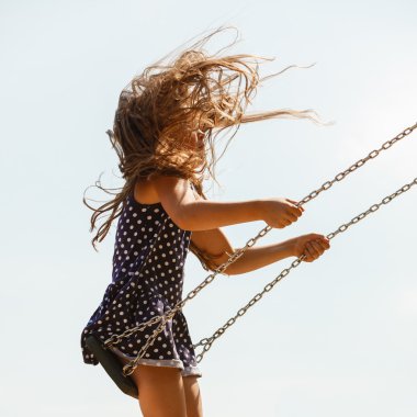Playful crazy girl on swing. clipart