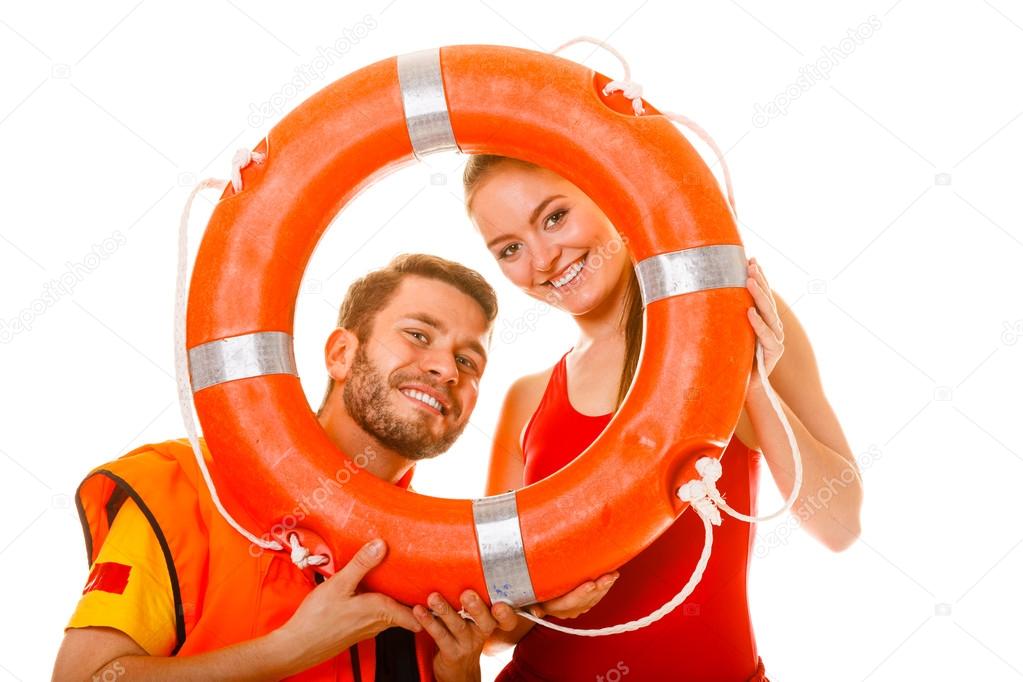 Lifeguards in life vest with ring buoy having fun. Stock Photo by