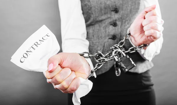 Businesswoman with chained hands holding contract — Stock Photo, Image