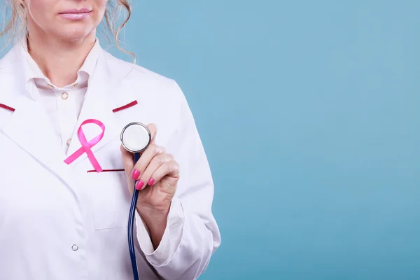 Pink ribbon with stethoscope on medical uniform. — Stock Photo, Image