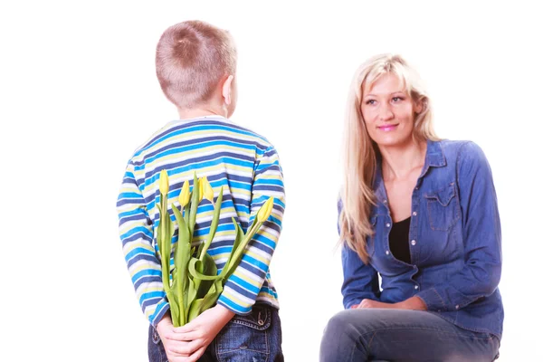 Little boy with mother hold flowers behind back. — Stock Photo, Image