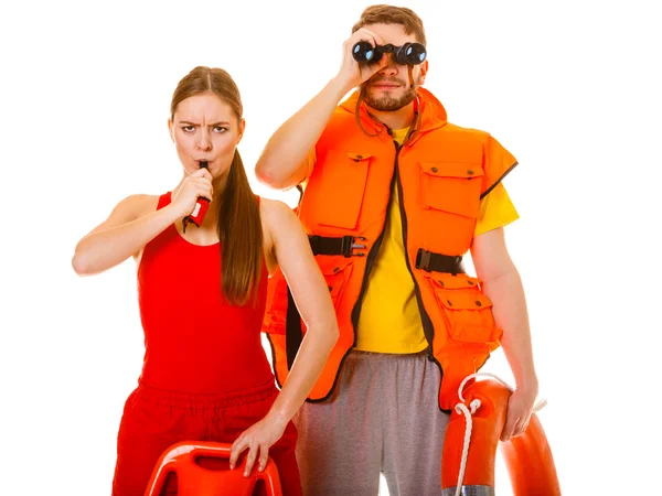 Lifeguards in life vest with ring buoy whistling. — Stock Photo, Image