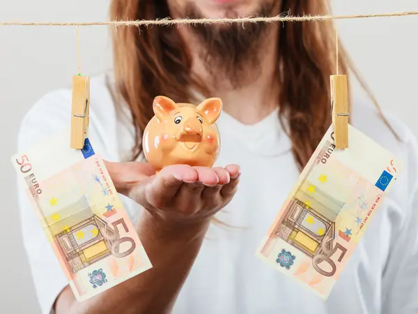 Man holding moneybox piggybank — Stock Photo, Image