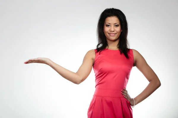 Woman  in red dress holding open palm — Stock Photo, Image