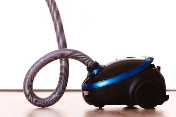 Vacuum cleaner on wooden floor. — Stock Photo, Image