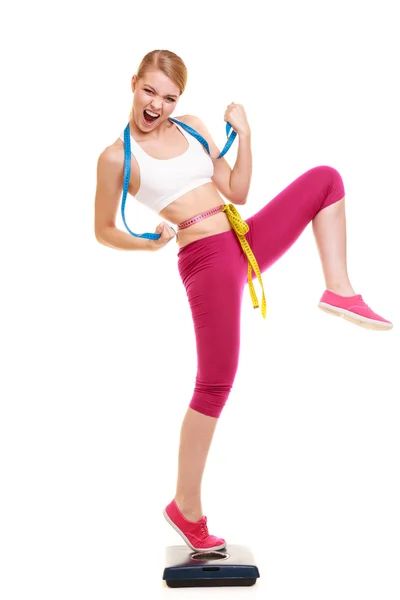 Woman clenching fists measuring on weighing scale. — Stock Photo, Image