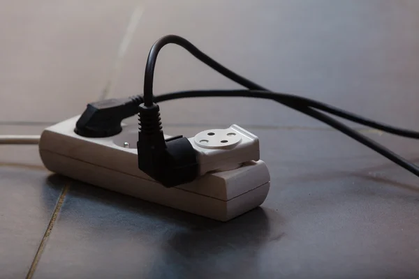 Electrical cords connected to power socket — Stock Photo, Image