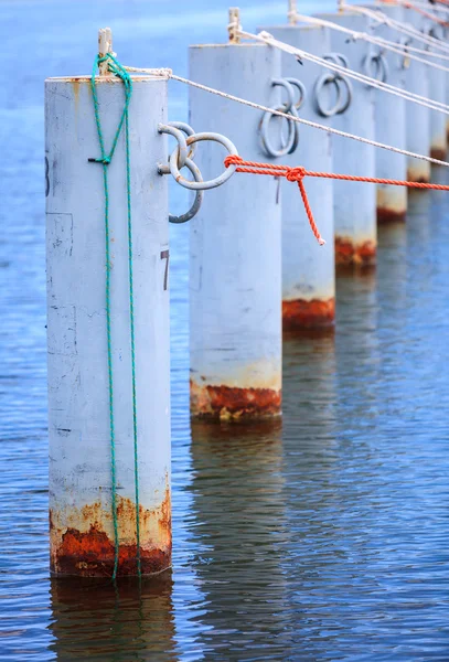 Row of metal bollards on the dock — Stock Photo, Image