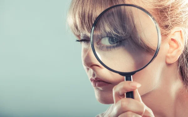 Girl holding on eye magnifying glass — Stock Photo, Image