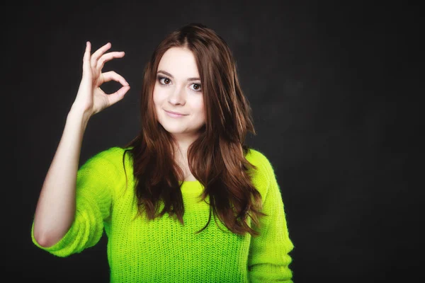 Teen girl showing ok sign hand gesture on black — Stock Photo, Image