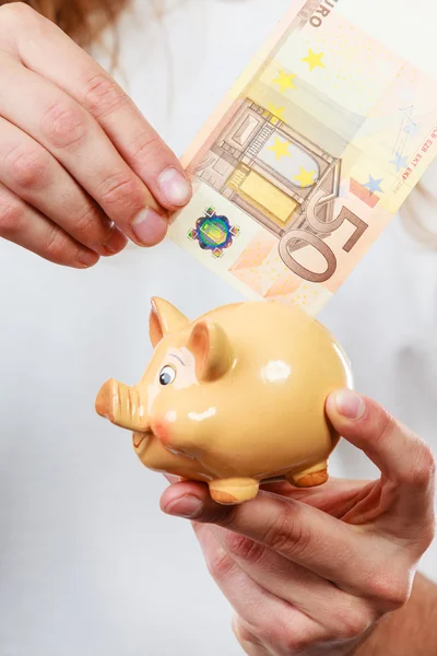 Male hands with banknote and piggybank — Stock Photo, Image