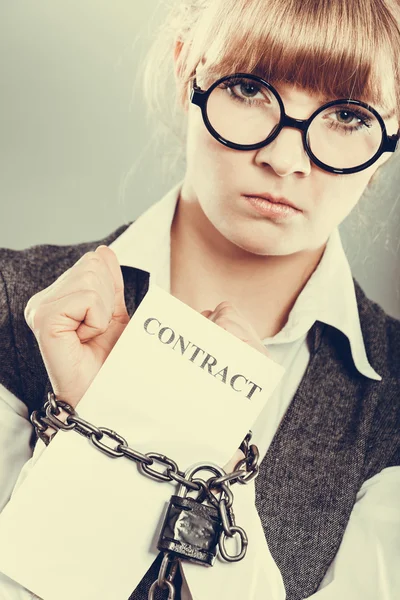 Businesswoman with chained hands holding contract — Stock Photo, Image