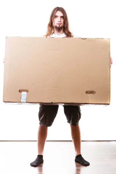 Delivery man holding a paper box. — Stock Photo, Image