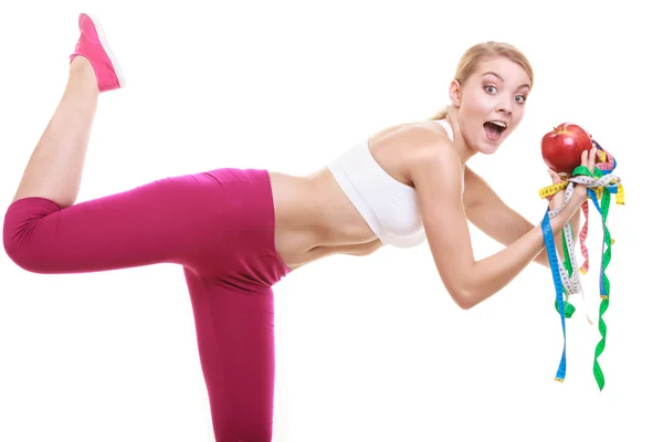 Funny woman holding apple and tape measures. — Stock Photo, Image