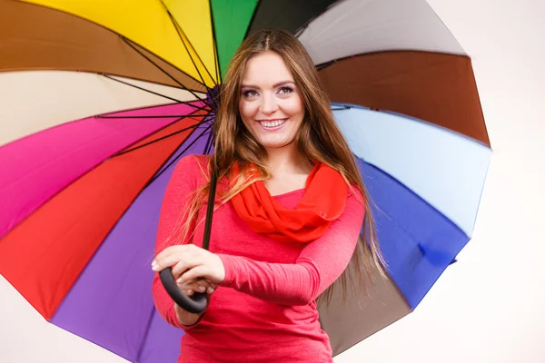 Woman standing under multicolored umbrella — Stock Photo, Image