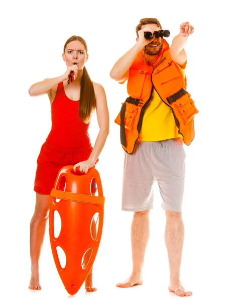 Lifeguards in life vest with rescue buoy whistling — Stock Photo, Image