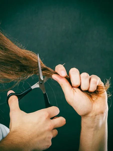 Male hands cutting  hair