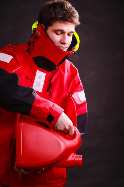 Man in oilskin with bottle. — Stock Photo, Image