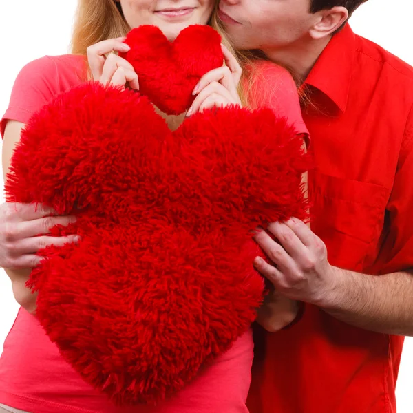 Couple holds red heart shaped pillows love symbol Stock Image