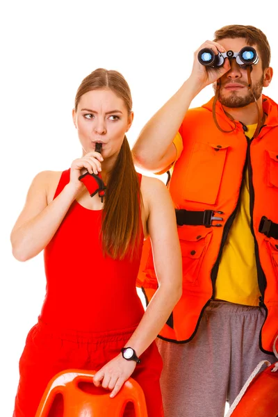 Lifeguards in life vest with ring buoy whistling. — Stock Photo, Image