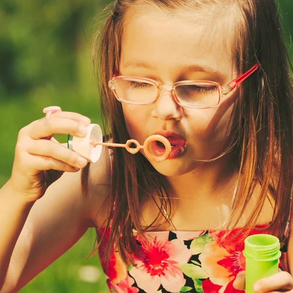 Little girl child blowing soap bubbles outdoor. — Stock Photo, Image