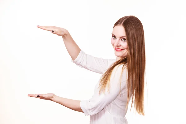 Woman uses hands to indicate area of frame, copy space for product — Stock Photo, Image