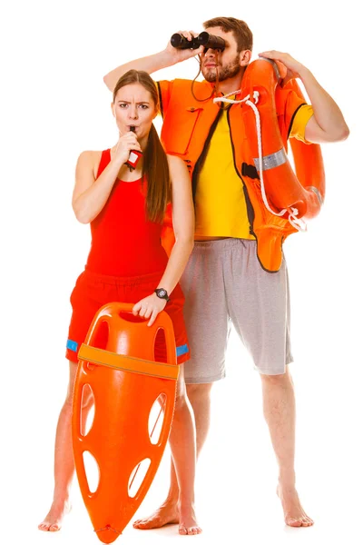 Lifeguards in life vest with ring buoy whistling. — Stock Photo, Image