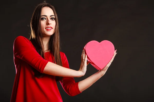 Girl in red holding heart box. — Stock Photo, Image