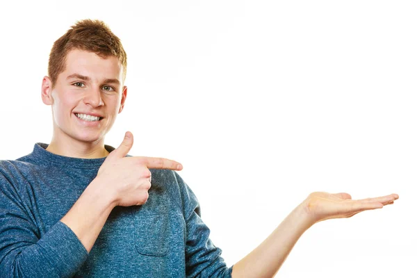 Young man holding open palm showing copy space — Stock Photo, Image