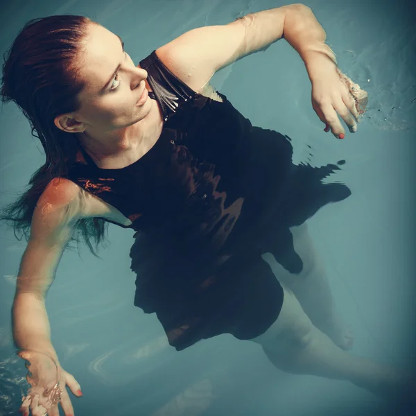 Sexy seductive woman in black dress in water. — Stock Photo, Image