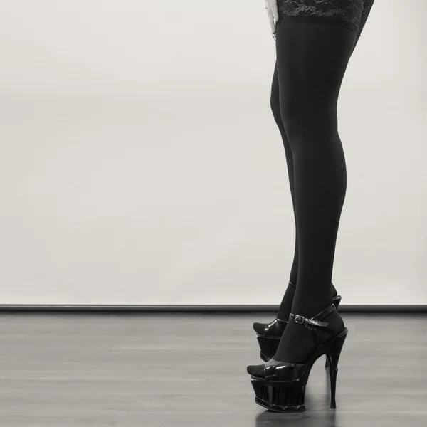 Sexy longues jambes féminines en noir . — Photo
