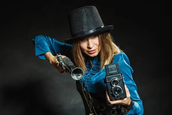 Steampunk with old retro camera and pistol. — Stock Photo, Image
