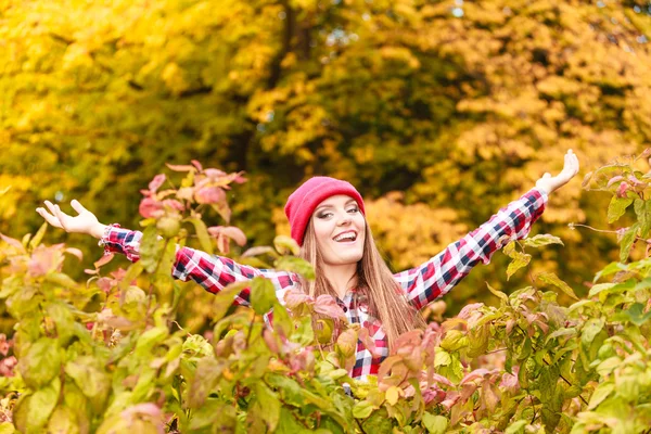 Femme dans le parc d'automne jetant des feuilles dans l'air — Photo