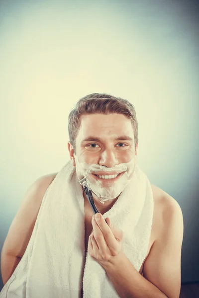 Happy man shaving using razor with cream foam. — Stock Photo, Image