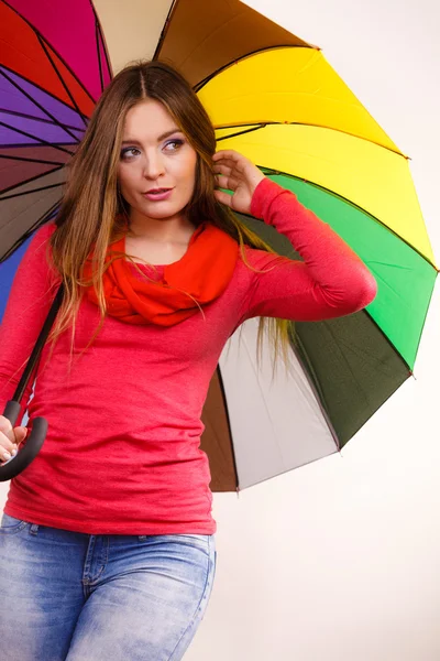 Woman standing under multicolored umbrella — Stock Photo, Image