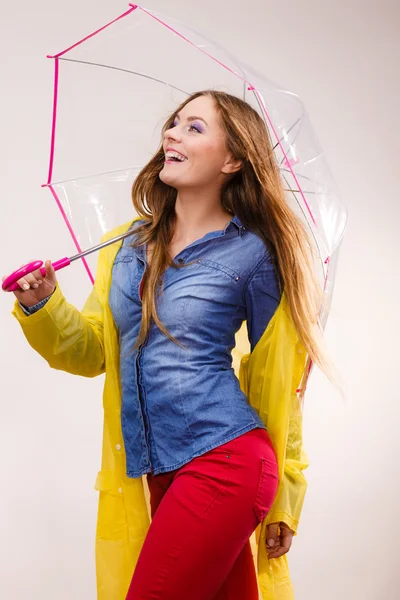 Wanita mengenakan mantel tahan air di bawah payung — Stok Foto