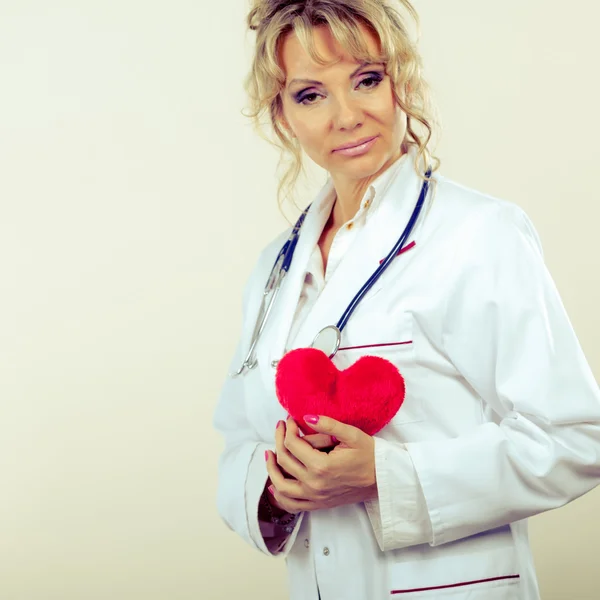 Female cardiologist with red heart. — Stock Photo, Image