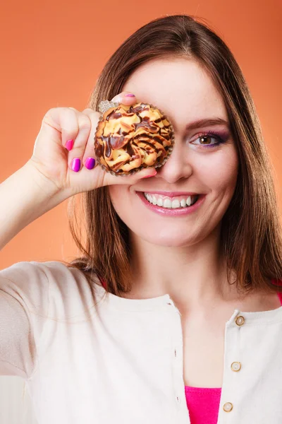 Divertida mujer sostiene pastel en la mano cubriendo su ojo —  Fotos de Stock