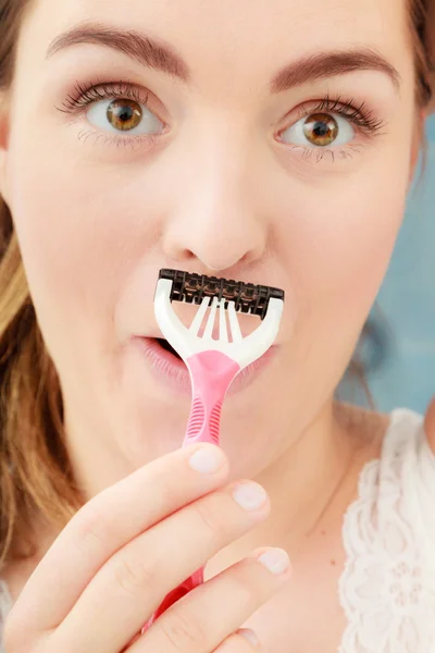 Woman shaving mustache with razor shaver. Hygiene. — Zdjęcie stockowe