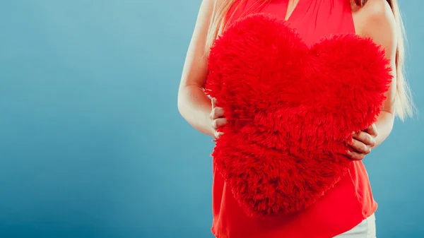 Heart shape pillow in hands. Valentines day love — Stock Photo, Image