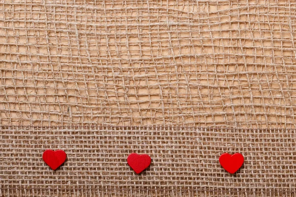 Corações vermelhos em pano abstrato fundo — Fotografia de Stock