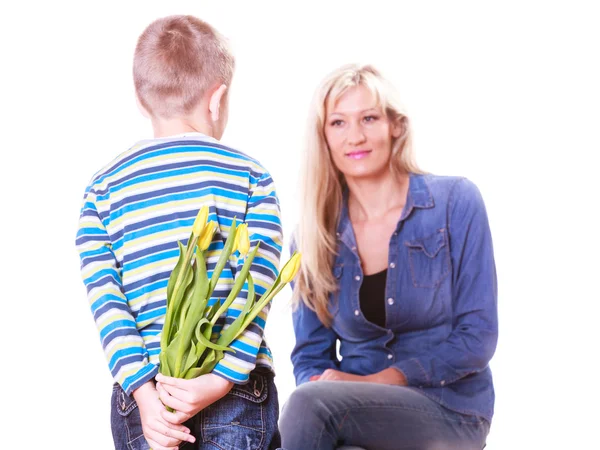 Little boy with mother hold flowers behind back. — Stock Photo, Image