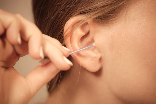 Woman cleaning ear with cotton swabs closeup — Stock Photo, Image